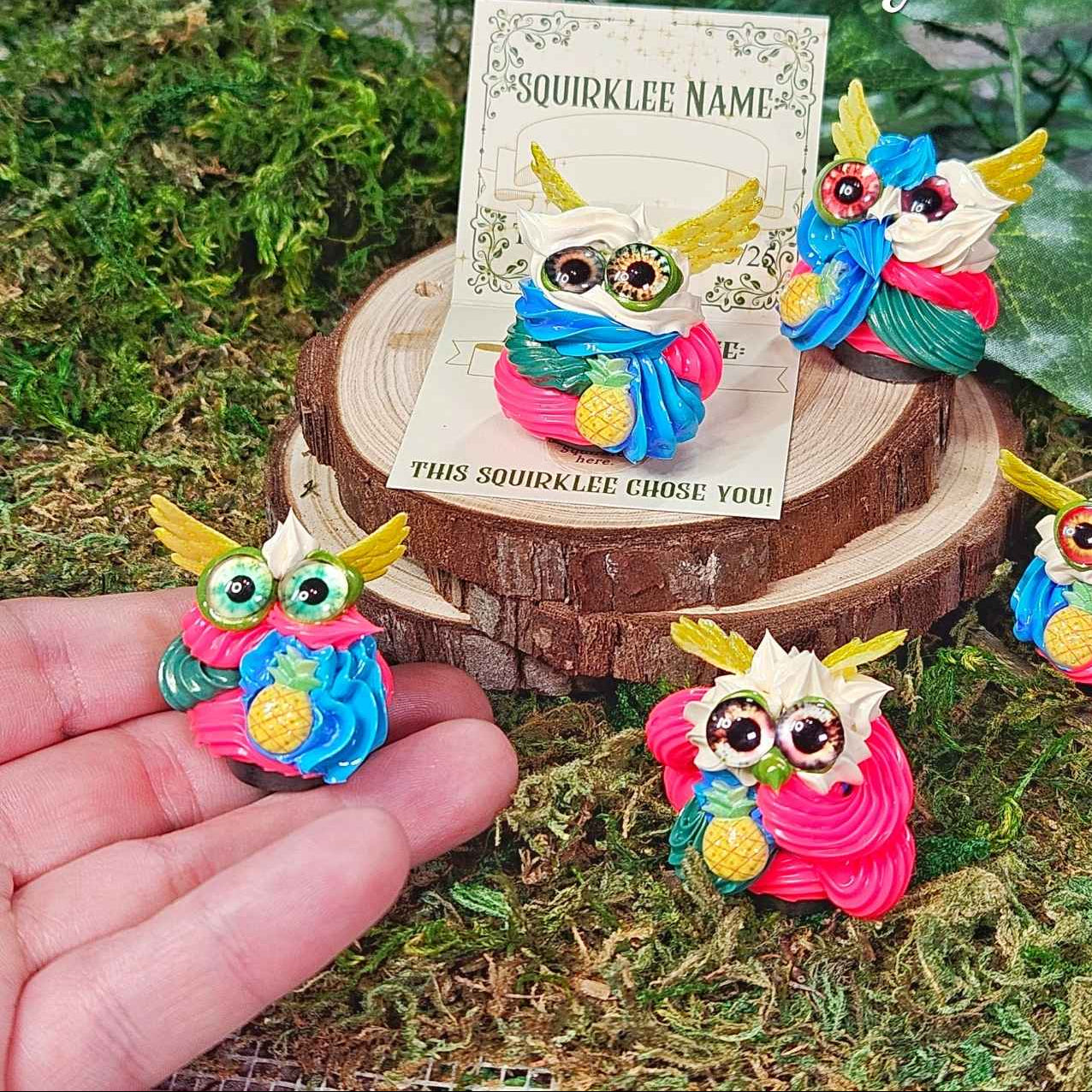 tiny frosting creatures called Squirklees, in hot pink, blue, yellow and green. each has a micro pineapple, part of the Tikiwhirl Blitzy family