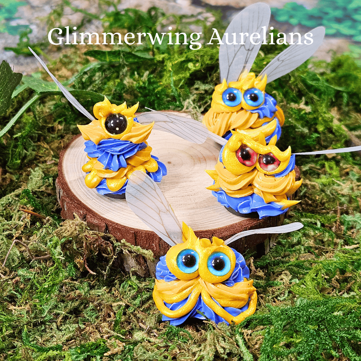 Four colorful winged frosting creatures on a wooden stump with 'Glimmerwing Aurelians' text above.