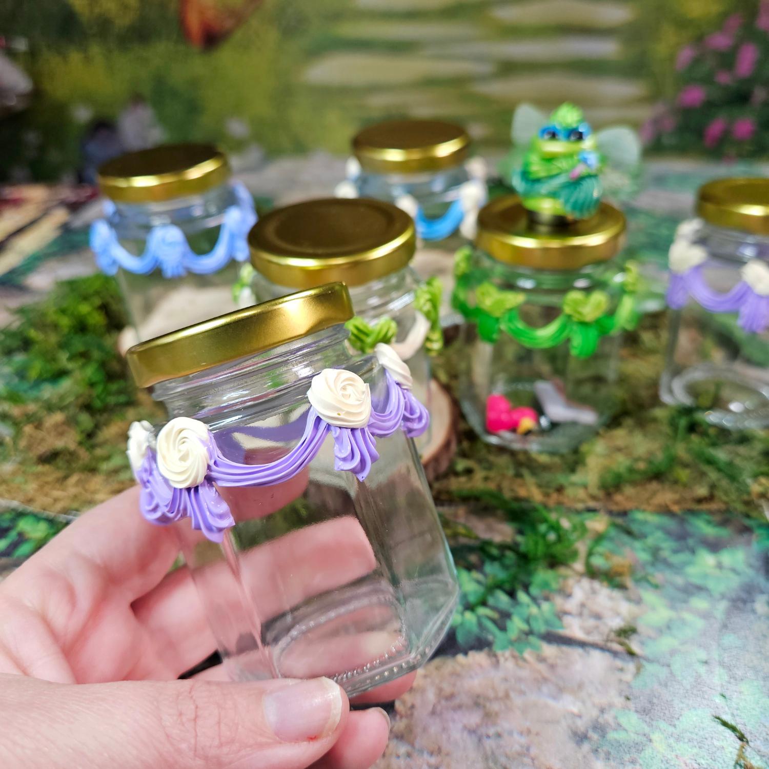 hand holding a glass jar with frosting trim, called a jarbliette, used in Squirklee lore