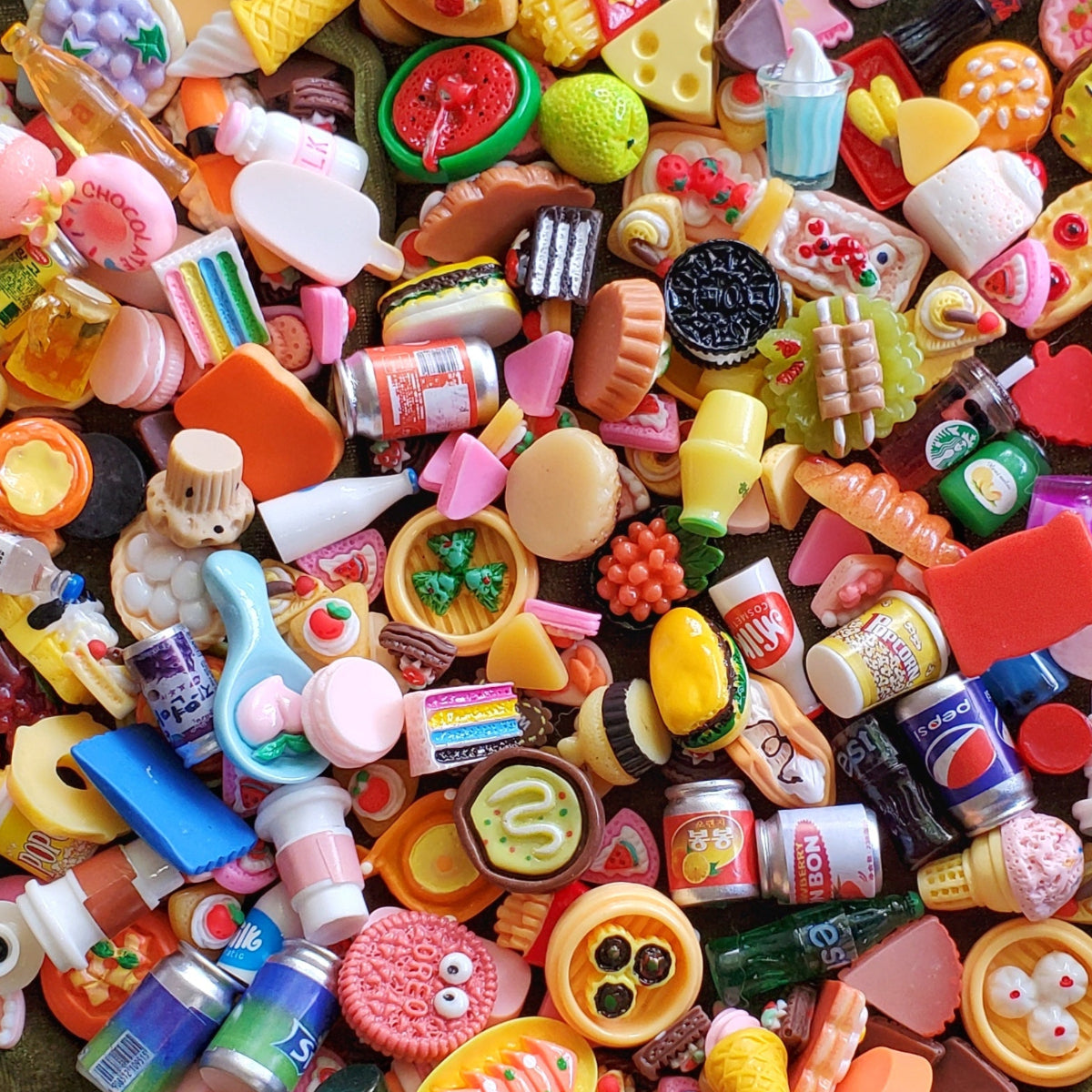 Close up of tiny miniature foods. Very colorful sodas, cakes, pies, cookies, ice creams and various sweet treats.