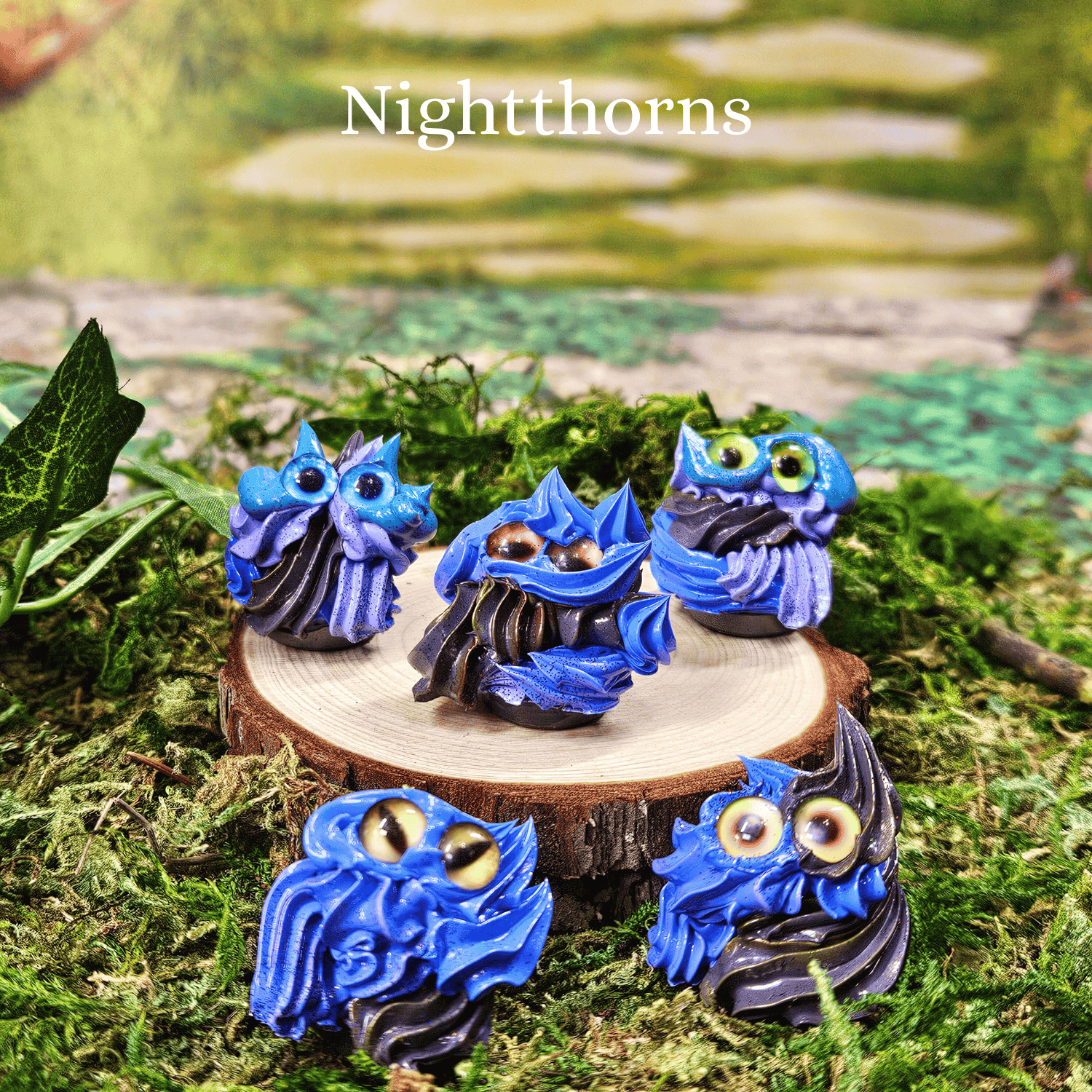 Set of blue frosting fantasy creatures on a wooden stump with 'Nightthorns' text above.